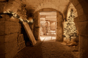 The medieval crypt decorated with lights and a tree for Christmas at Oxford Castle Prison